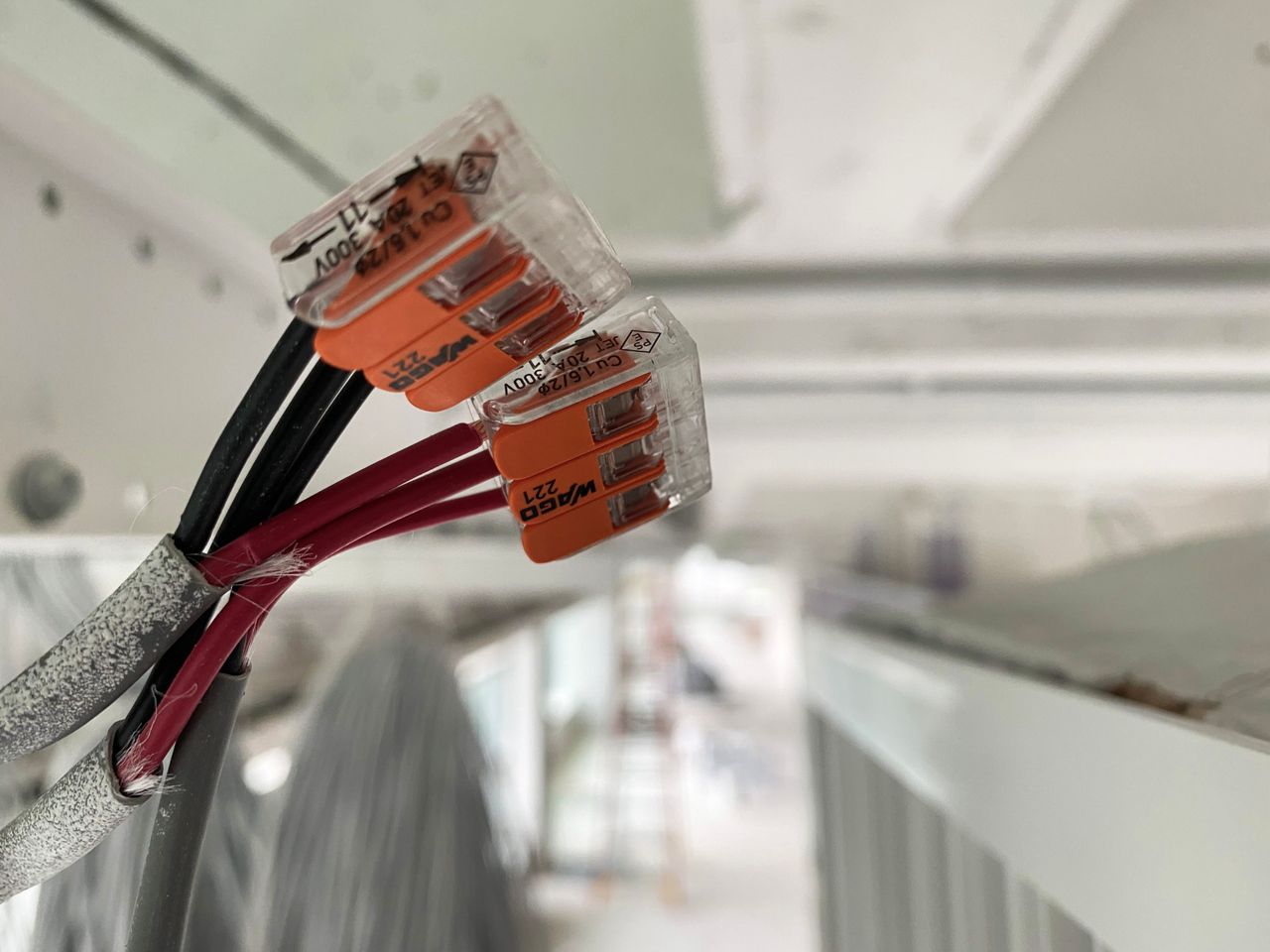 services-04 Detailed view of splicing connectors and wires in an indoor setting, ideal for technology-related projects.
